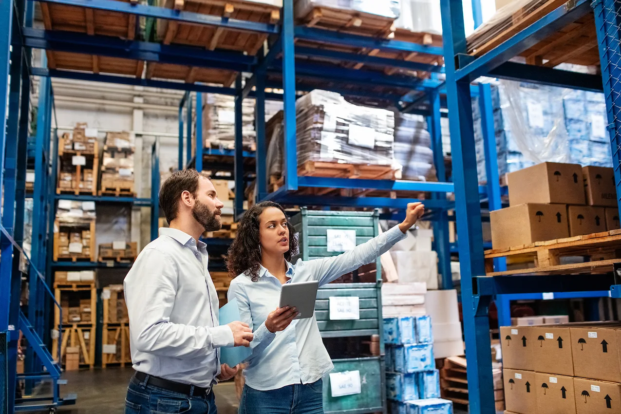 people in warehouse looking at boxes